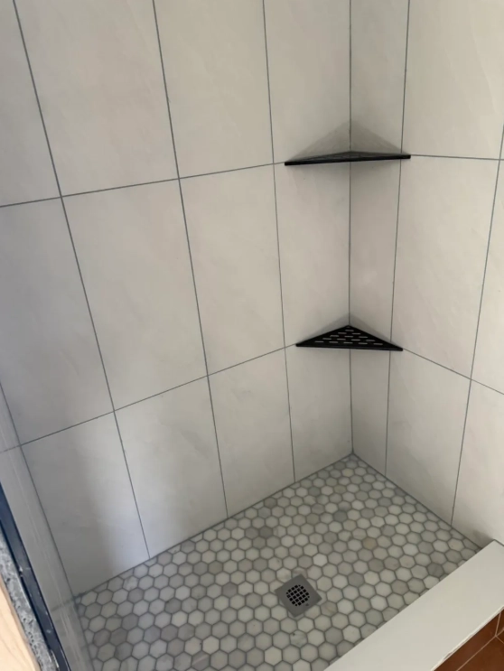 Calacatta marble shower walls with hexagon mosaic floor tile
